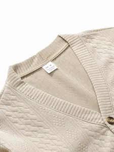 Close-up detail of the collar and size label on a beige textured men's knit cardigan.