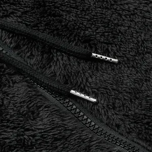 Detailed texture of black fleece jacket with high-quality zipper and metal-tipped drawstrings
