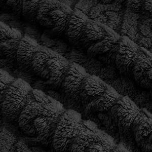 Close-up of black jacquard plush fleece fabric texture for warm winter hoodie.