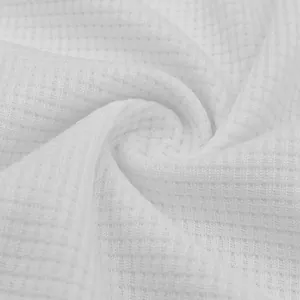Macro detail of white waffle knit fabric texture for men's summer POLO shirt