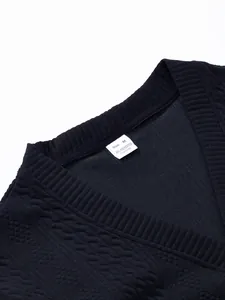 Close-up of V-neck collar and size tag on men's black textured knit cardigan