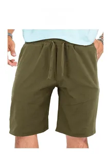 Close-up detail of olive green men's loose sport shorts with functional drawstring waist