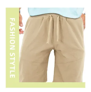 Detail view of men's trendy khaki sports shorts with elastic drawstring waistband.