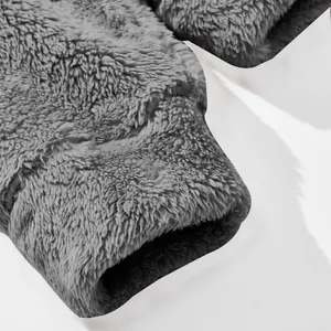Detail view of the soft grey fleece texture on the cuff of a winter coat.