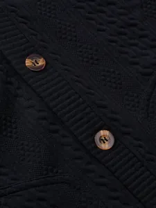 Close-up of black men's jacquard knit cardigan with vintage brown button details