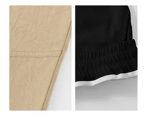 Close-up detail showing fabric stitching and elastic waistband on men's sports shorts.