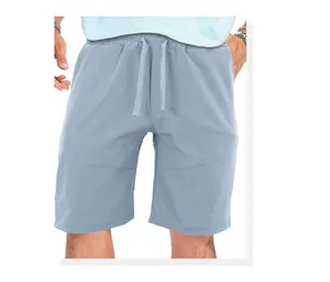 Close-up of lightweight men's loose sports shorts with drawstring waist in light blue