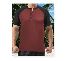 Detailed view of a men's burgundy and black color-block Henley shirt with raglan sleeves