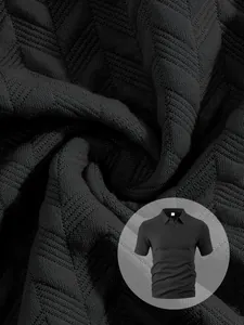 Close-up of high-quality black jacquard fabric texture on a modern men's casual polo shirt