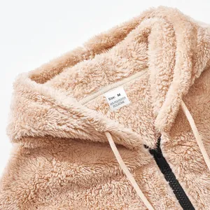 Close-up of beige fleece hooded jacket showing fuzzy texture and size label