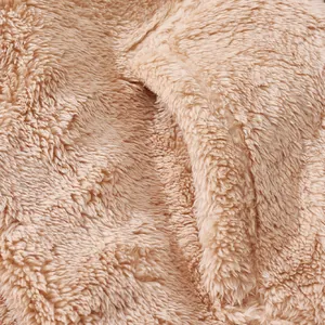 Close-up detail of soft light brown fluffy fleece fabric texture for winter jacket