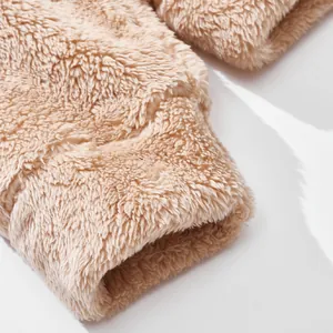 Macro view showing the soft beige plush fleece material texture on hoodie sleeve cuff.