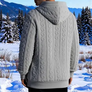 Back view of a grey cable-knit textured fleece hoodie set against a scenic snowy landscape