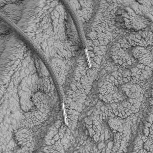 Detailed macro view of the soft grey sherpa fleece fabric and metallic drawstring aglets