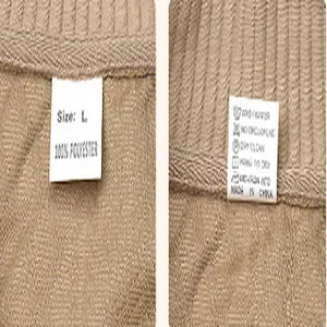 Dettaglio dell'etichetta del capo con taglia L e trama del tessuto jacquard 100% poliestere
