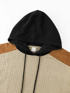Close-up of men's hooded sweatshirt featuring waffle texture and color-blocking design
