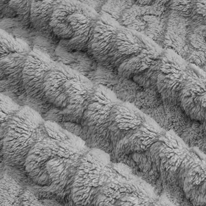 Macro detail of the grey jacquard double-sided fleece fabric with soft wavy texture