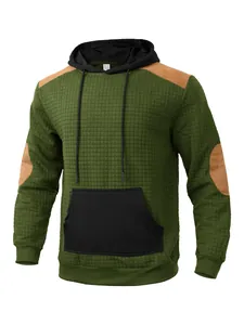 Detailed macro view of green quilted hooded sweatshirt with patchwork design for men