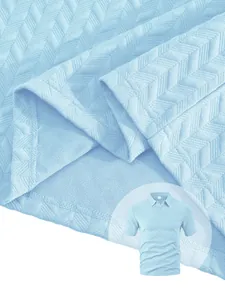 Close-up detail of light blue herringbone textured fabric on a stylish men's polo shirt