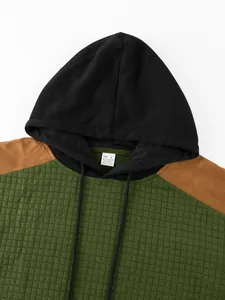 Detailed view of men's color-block quilted hoodie featuring a textured square pattern
