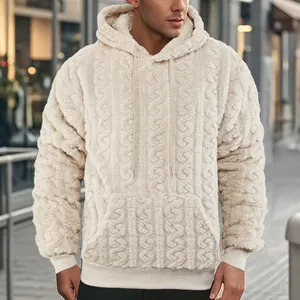 Close-up view of the plush cable-knit texture on a men's warm off-white hooded sweatshirt