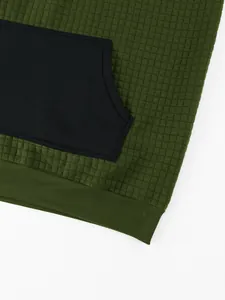 Close-up detail of men's olive green hoodie featuring waffle grid texture and black pocket