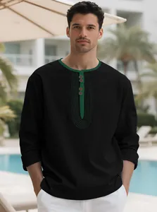 Close-up of black men's linen tunic with green contrast collar and buttons