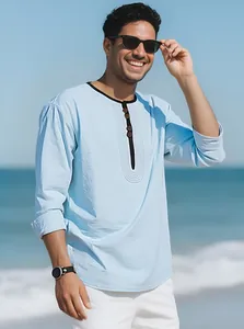 Detail of man wearing light blue breathable linen long sleeve t-shirt on sunny beach