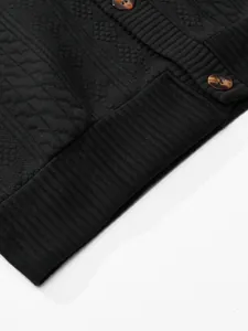 Close-up of black jacquard knit texture and ribbed hem on a vintage men's cardigan