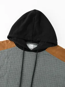 Close-up detail of men's grid pattern hoodie showing the hood, texture, and neck label.