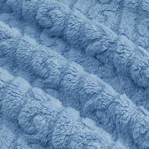 Close-up macro detail of soft light blue jacquard fleece fabric for warm winter hoodies.