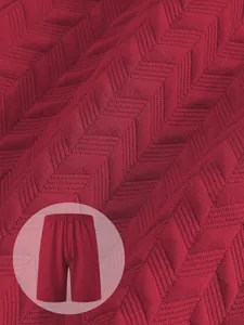 Macro detail of red men's shorts showing premium jacquard chevron texture fabric