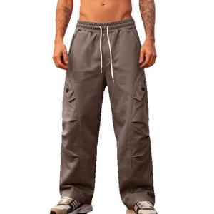 Men's casual loose straight-leg cargo pants with unique pleated details in brown color.