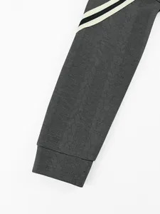 Close-up macro view of heavyweight jacquard hoodie sleeve featuring decorative stripe patterns