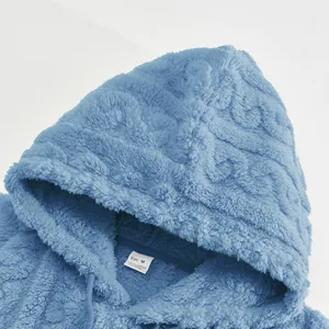 Macro view of soft blue jacquard fleece hoodie fabric and internal neck size tag