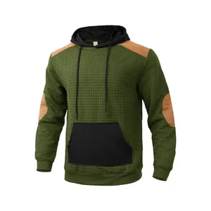 Men's olive green quilted hoodie with black kangaroo pockets and brown shoulder patches.