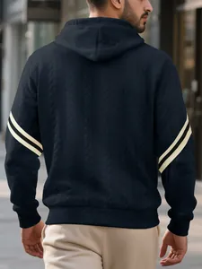 Detailed back view of men's navy blue cable-knit hoodie featuring cream sleeve stripes