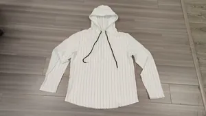 Detail view of a white men's long-sleeve hoodie with vertical black stripes and a drawstring hood.