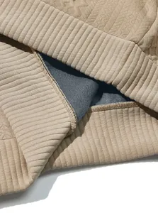 Close-up of heavy jacquard sweatshirt showing ribbed hem and inner lining texture