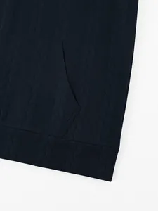 Macro detail showing navy blue heavyweight jacquard sweatshirt fabric and pocket design