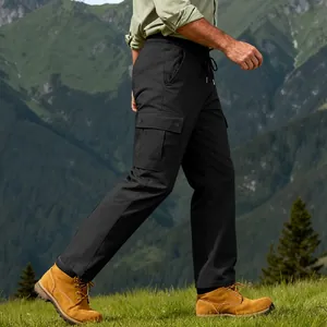 Side view of men's durable black cargo pants worn in a scenic mountain hiking environment