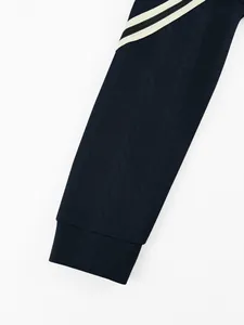 Close-up of textured cable-knit pattern on a heavyweight navy blue hoodie sleeve