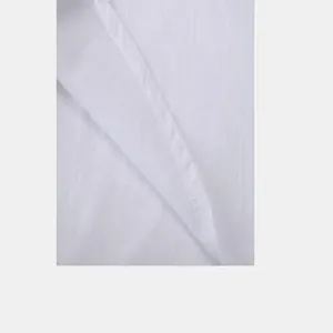 Close-up macro view of white slub cotton linen fabric and stitching on a men's shirt