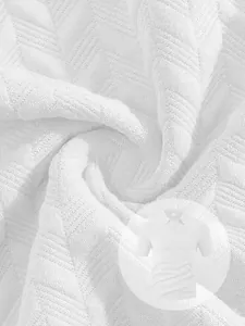 Close-up macro view of the white jacquard fabric texture on a breathable men's polo shirt