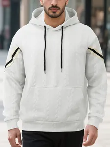 Detailed shot of heavy white jacquard hoodie featuring sleeve stripes and cable texture