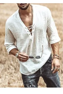 Detail view of men's white V-neck cotton linen shirt with lace-up collar and breathable fabric.