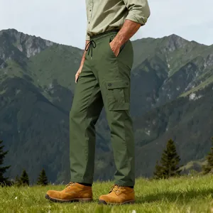 Detailed side view of olive green men's outdoor hiking cargo pants in a mountain setting