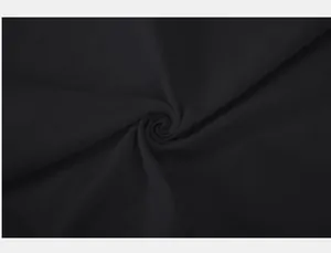 Close-up detail of black slub cotton linen fabric texture for men's Henley shirt
