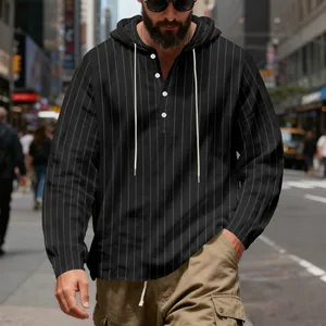 Close-up of men's black striped linen hoodie with buttons and drawstring detail