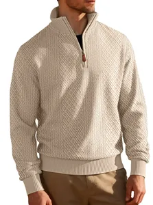 Detailed macro view of men's cream quarter-zip sweater with jacquard knit texture